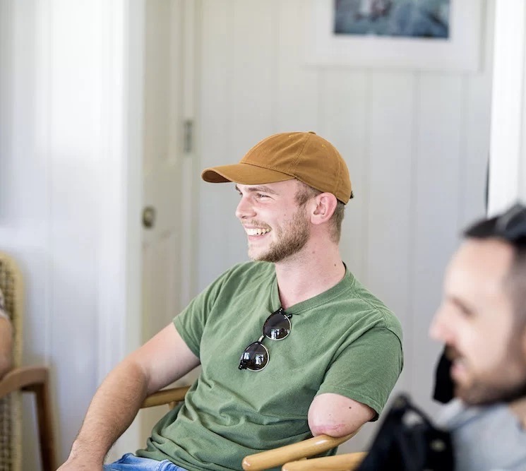 Josh smiles at his friends.