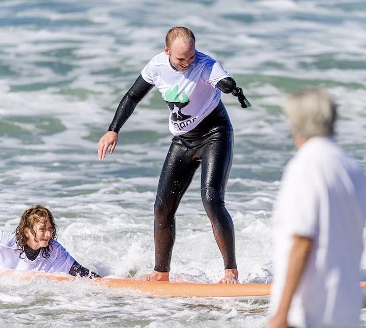 John learns to surf for the first time